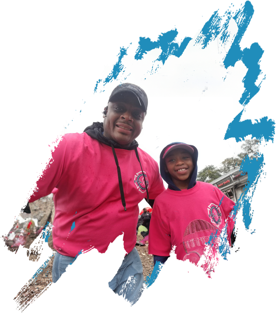 F.L.A.M.E. team members in pink shirts at a community event